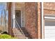 Charming front door with a decorative wreath and a brick facade at 420 Heritage Park Nw Trce # 22, Kennesaw, GA 30144