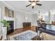 Cozy living room featuring a fireplace, wood floors, and a ceiling fan at 420 Heritage Park Nw Trce # 22, Kennesaw, GA 30144