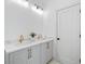 Modern bathroom featuring double sinks, stylish fixtures, and a granite countertop at 461 Maypop Ln, Woodstock, GA 30188