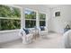 Bright bedroom nook features large windows with a scenic view, and chic accent chairs at 461 Maypop Ln, Woodstock, GA 30188