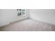 Cozy bedroom with plush carpet and a window offering a view of the neighborhood at 461 Maypop Ln, Woodstock, GA 30188