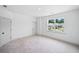 Bright bedroom with plush carpet and a large window showcasing the neighborhood at 461 Maypop Ln, Woodstock, GA 30188