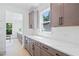 Counter features white backsplash, grey cabinets and stainless steel hardware at 461 Maypop Ln, Woodstock, GA 30188