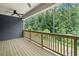 Inviting deck with wood railing, perfect for enjoying the serene views of the surrounding trees and landscape at 461 Maypop Ln, Woodstock, GA 30188