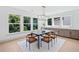 Bright dining room features four chairs, view of outside and built-in counter at 461 Maypop Ln, Woodstock, GA 30188
