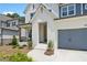 Charming two-story home featuring a two-car garage, white brick, and well manicured landscaping at 461 Maypop Ln, Woodstock, GA 30188