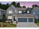 Charming two-story home with a three-car garage, covered porch, and well-manicured landscaping at 461 Maypop Ln, Woodstock, GA 30188