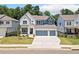 Beautiful two-story home with a three-car garage, manicured lawn, and inviting curb appeal at 461 Maypop Ln, Woodstock, GA 30188