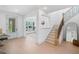 Bright foyer featuring a staircase with modern railings and hardwood floors, creating a welcoming entrance at 461 Maypop Ln, Woodstock, GA 30188