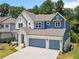Inviting two-story home with a three-car garage and beautifully landscaped yard at 461 Maypop Ln, Woodstock, GA 30188