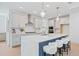 Bright kitchen featuring a large center island with white quartz countertops, stainless steel appliances and breakfast bar at 461 Maypop Ln, Woodstock, GA 30188