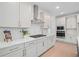 Bright, open concept kitchen with stainless steel appliances, white cabinets and eat-in dining area at 461 Maypop Ln, Woodstock, GA 30188