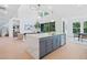 Open-concept kitchen featuring an island, stainless steel appliances, and a seamless transition to the living space at 461 Maypop Ln, Woodstock, GA 30188