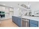Bright, open kitchen with stainless steel appliances, blue island and eat in kitchen overlooking living area at 461 Maypop Ln, Woodstock, GA 30188