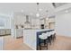 Bright kitchen featuring a center island with white quartz countertops, stainless steel appliances and breakfast bar at 461 Maypop Ln, Woodstock, GA 30188