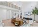 Bright living room boasts high ceilings, hardwood floors, and modern decor, creating an inviting and stylish atmosphere at 461 Maypop Ln, Woodstock, GA 30188