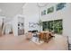 Spacious living room featuring high ceilings, large windows, stylish decor, and seamless access to the outdoors at 461 Maypop Ln, Woodstock, GA 30188