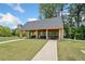 Open-air pavilion with picnic tables and surrounding greenery for outdoor enjoyment at 461 Maypop Ln, Woodstock, GA 30188