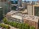 Aerial view of city apartment complex with a rooftop pool and surrounding city buildings at 845 Spring Nw St # Ph4, Atlanta, GA 30308