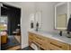 Bright bathroom features a marble countertop, double sinks, with a view into the main bedroom at 845 Spring Nw St # Ph4, Atlanta, GA 30308