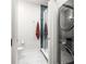 Modern full bathroom featuring a stylish shower, toilet, and in-unit washer and dryer at 845 Spring Nw St # Ph4, Atlanta, GA 30308
