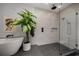 Bathroom with glass shower, modern bathtub, gray hexagon tile flooring, and a beautiful green plant at 845 Spring Nw St # Ph4, Atlanta, GA 30308