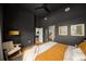 Stylish bedroom featuring dark walls, hardwood floors, and a large window with city views at 845 Spring Nw St # Ph4, Atlanta, GA 30308