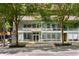 Midcity Lofts building entrance with modern glass facade and landscaped planters at 845 Spring Nw St # Ph4, Atlanta, GA 30308