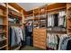 Walk-in closet with custom wood shelving, drawers, and ample storage space for clothing and accessories at 845 Spring Nw St # Ph4, Atlanta, GA 30308