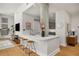 Modern kitchen with a sleek breakfast bar, stools, and a view into the adjacent living area at 845 Spring Nw St # Ph4, Atlanta, GA 30308