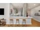 Modern kitchen with bar-style seating featuring a sleek design, stylish stools, and a functional layout at 845 Spring Nw St # Ph4, Atlanta, GA 30308