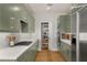 Modern kitchen with sage cabinets, quartz countertops, stainless appliances, and pantry at 845 Spring Nw St # Ph4, Atlanta, GA 30308