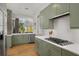 Bright kitchen featuring sage cabinets, stainless appliances, quartz countertops, and hardwood floors at 845 Spring Nw St # Ph4, Atlanta, GA 30308
