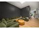 Modern living room with hardwood floors, large green sectional sofa and a skylight at 845 Spring Nw St # Ph4, Atlanta, GA 30308