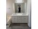 Bathroom with double vanity and white marble countertop at 955 Loch Forest Way, Riverdale, GA 30296