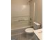 Bathroom featuring a tub with shower and white fixtures at 955 Loch Forest Way, Riverdale, GA 30296