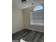 Bright bedroom with a window and wood floors at 955 Loch Forest Way, Riverdale, GA 30296