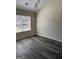 Bedroom with new wood floors and a large window providing natural light at 955 Loch Forest Way, Riverdale, GA 30296