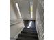 Staircase from entryway with gray wood grain stairs and white railings at 955 Loch Forest Way, Riverdale, GA 30296