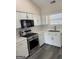 Kitchen with white cabinets, stainless steel appliances, and backsplash at 955 Loch Forest Way, Riverdale, GA 30296