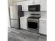 Updated kitchen featuring stainless steel appliances and white cabinetry at 955 Loch Forest Way, Riverdale, GA 30296