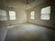 A quaint bedroom is displayed with three windows and a ceiling fan at 247 Whitaker Nw Cir, Atlanta, GA 30314