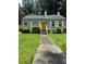 Charming single-story home with a yellow door, a well-manicured lawn and shrubbery at 247 Whitaker Nw Cir, Atlanta, GA 30314