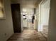 Hallway view looking into the kitchen area with appliances and wood flooring at 247 Whitaker Nw Cir, Atlanta, GA 30314