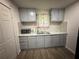 Bright kitchen with stainless steel sink, gray cabinets and updated appliances at 247 Whitaker Nw Cir, Atlanta, GA 30314