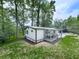 Rear exterior of home has a deck, a well manicured lawn and a wooded backdrop at 337 Theodore Cox Cir, Canton, GA 30114