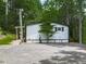 A single-story home featuring a white exterior, covered porch and gravel driveway at 337 Theodore Cox Cir, Canton, GA 30114