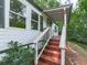 A covered front entrance with wooden stairs leading to a single-story home at 337 Theodore Cox Cir, Canton, GA 30114