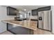 Modern kitchen featuring butcher block countertops, stainless steel appliances, and sleek black cabinetry at 337 Theodore Cox Cir, Canton, GA 30114