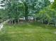 Lush green property surrounding a quaint home, creating a serene and private setting at 337 Theodore Cox Cir, Canton, GA 30114